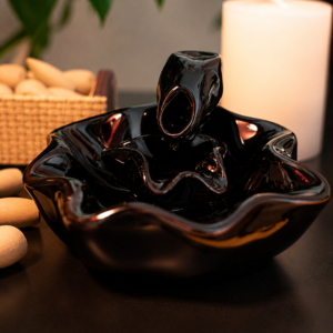 Incensário cascata decorativo flor de lótus produzido em cerâmica com efeito visual de fumaça descendente.